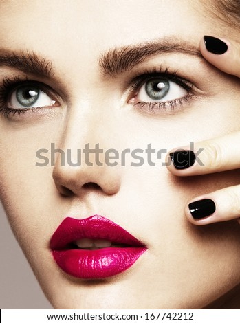 Close-up beauty portrait of beautiful model with bright make-up and manicure. Black nails, pink lips