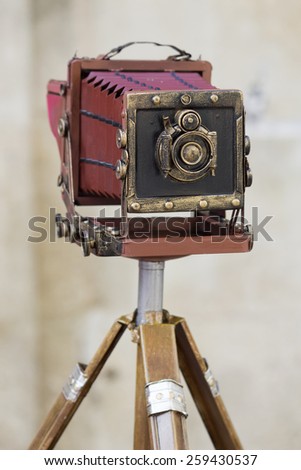 Old large format photo camera on a tripod on the street outdoors. Stock photography.