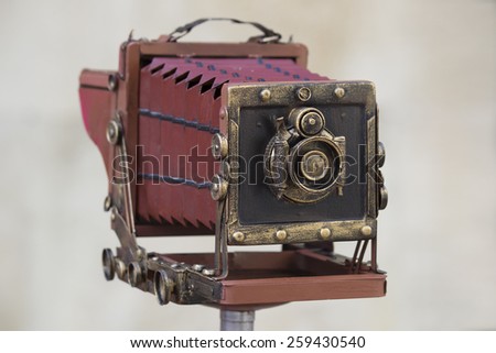 Old large format photo camera on a tripod outdoors. Stock photography.