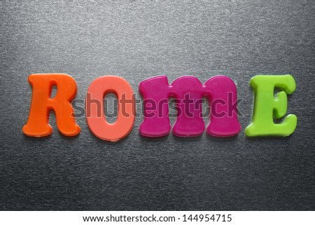 the word rome spelled out using colored fridge magnets