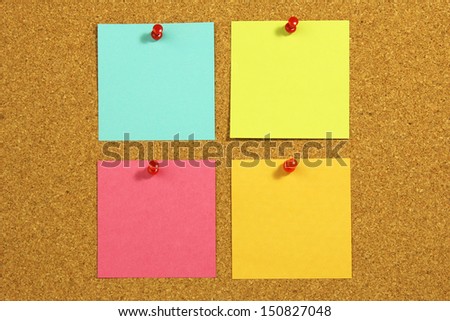 four blank note card on a cork board
