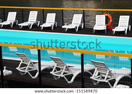 swimming pool with white chairs