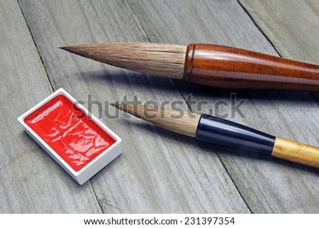 asian writing brushes and ink for calligraphy on wooden background