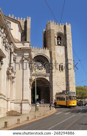 LISBON, APRIL 1: famous yellow tram number 28 in front of the Lisbon Cathedral; on April 1, 2015 Lisbon, Portugal.