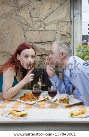Man share a gossip - secret. Restaurant scene
