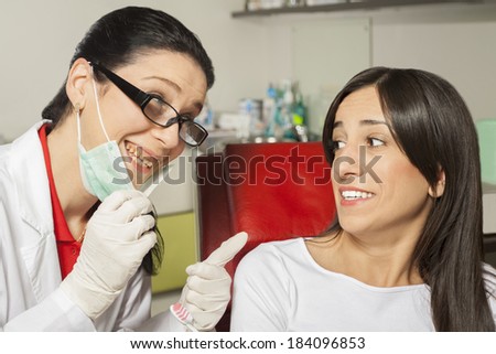 Dentist showing his bad teeth. Appalled patient and the dentist with neglected teeth.