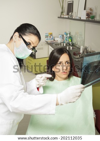 Patient looking at x-ray while his dentist explains the problem.