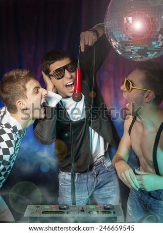 DJ - MC and friends at a party screaming - singing into a microphone.