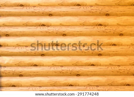 Background in the form of a wall made of round pine logs