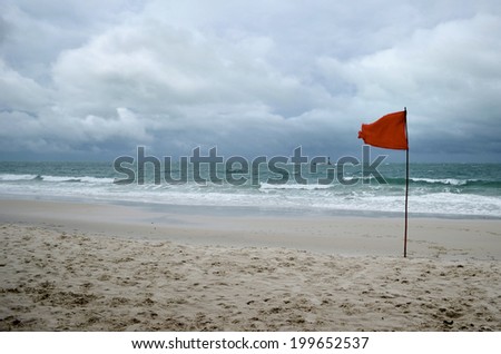 red warning flag on beach