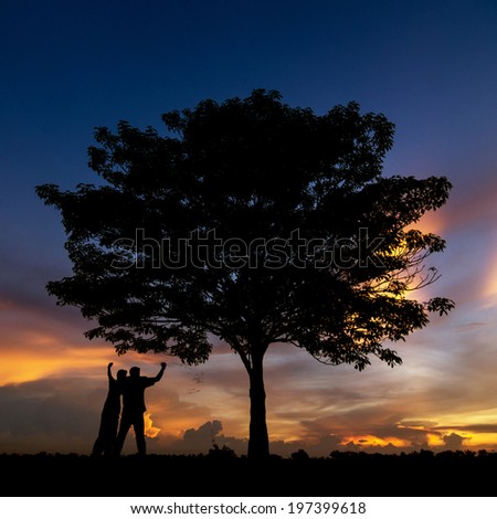 Beautiful landscape with silhouette of trees and two men happy. Beautiful sunset sky