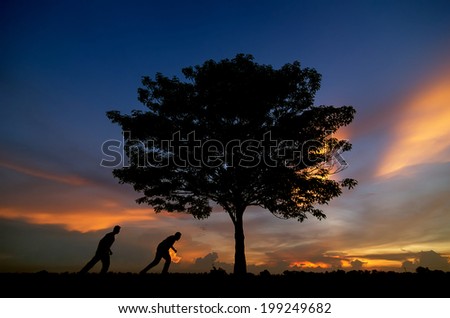 Beautiful landscape with silhouette of trees and two men happy. Beautiful sunset sky