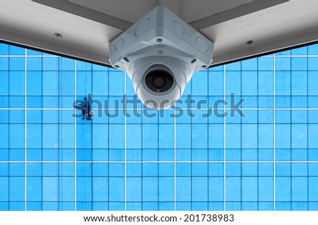 The security cameras on a balcony high building. Cleaning exterior glass