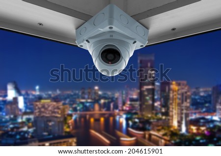 The security cameras on a balcony high building. City view at night
