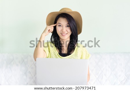 Happy young beautiful asian woman using laptop indoor, Concept I think.