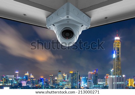 The security cameras on a balcony high building. City view at night