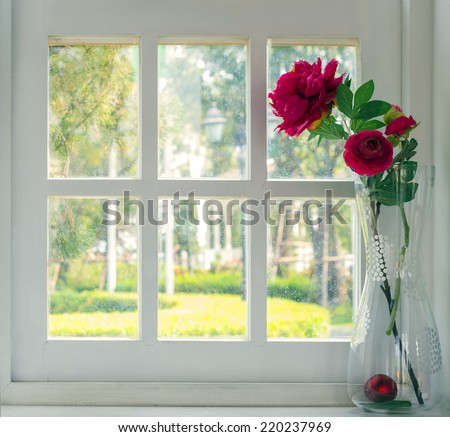 Bouquet of artificial flowers in a window to look through the window, relaxation concept