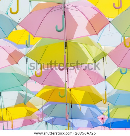 A lot of multicolored umbrellas. Color umbrellas urban decoration.