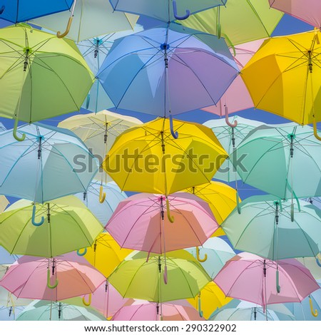 A lot of multicolored umbrellas. Color umbrellas urban decoration.