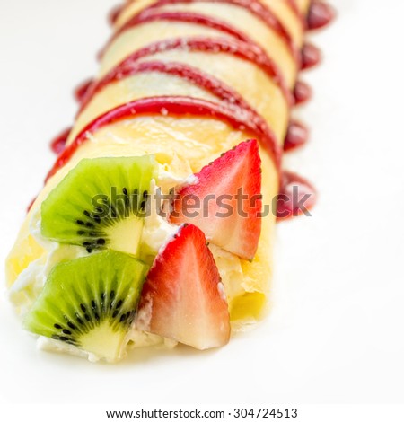 Roll crepes with berries and kiwi. Crepes, strawberry, raspberry, blueberry pancake topping.