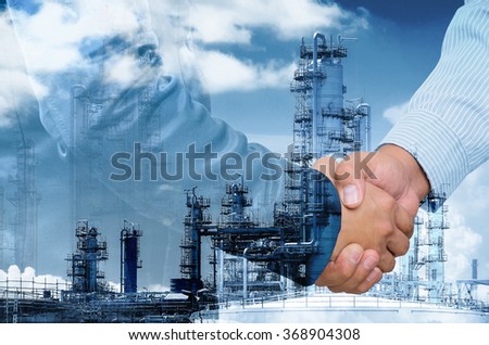 Double exposure of businessman handshake on industrial background.