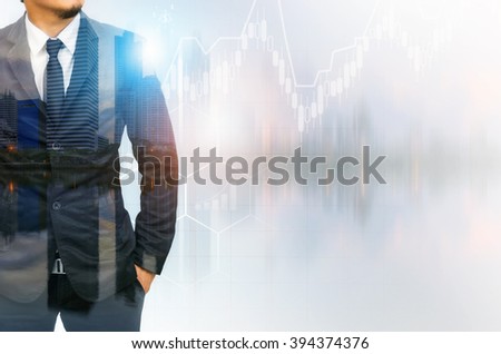 Double exposure of businessman with cityscape and financial graph on blurred building background.