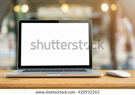Conceptual workspace, Laptop with blank screen on table.