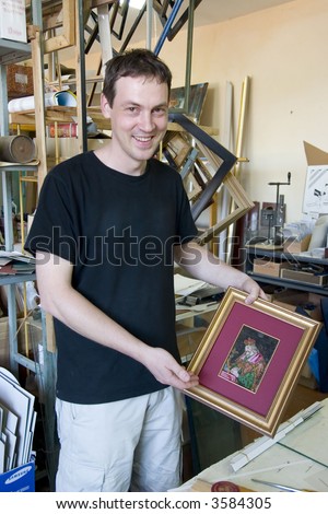 smiling man framing the antique bean mosaic