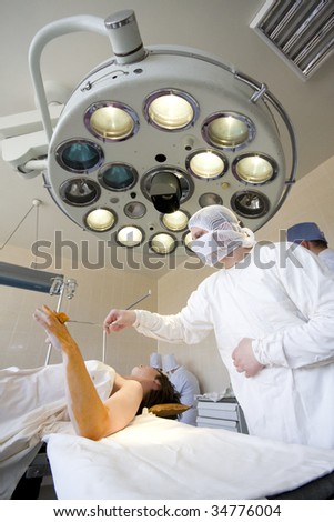 Surgeon is preparing to the operation on the arm