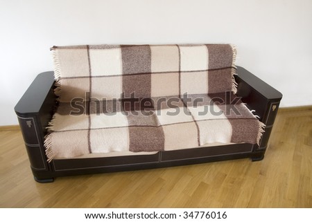 classic sofa covered by rug on the wooden floor