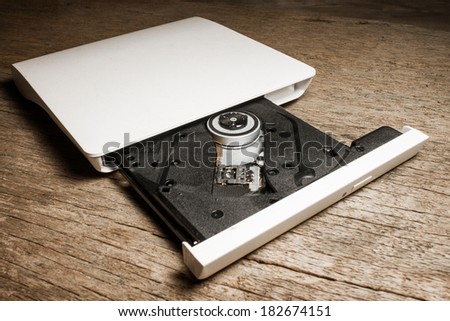 Portable Cd / Dvd external drive on wooden background