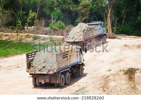 Excavator loading dumper truck tipper in construction site