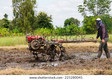 Thai farmer using walking tractors for cultivated soil for rice