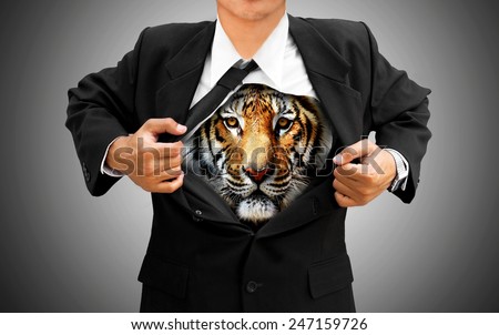 businessman acting and tearing his shirt off showing Tiger brave underneath his suit body