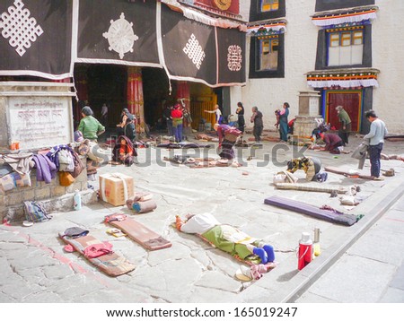 LHASA TIBET - FEB 21: Tibetan worshippers from all over Tibet pray in front of their holiest temple, the Jokhang Temple(UNESCO World heritage site) on February 21, 2009 in Lhasa, Tibet.