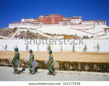 LHASA, TIBET - FEB 14: Potala Palace and Chinese armed police warrior on February 14, 2009 in Lhasa, Tibet. Potala Palace is the holiest site in Tibetan Buddhism. February 14, 2009 in Lhasa,Tibet