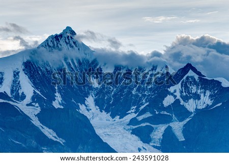 DEQIN, CHINA - Aug 3 2014: Evening View of Meili Snow Mountain Nature Reserve. a famous landscape in Deqin, Yunnan, China.