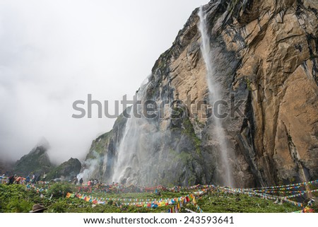 YUBENG, CHINA - Aug 10 2014: Holy Waterfall at Yubeng Village. a famous landscape in the Tibetan village of Deqin, Yunnan, China.