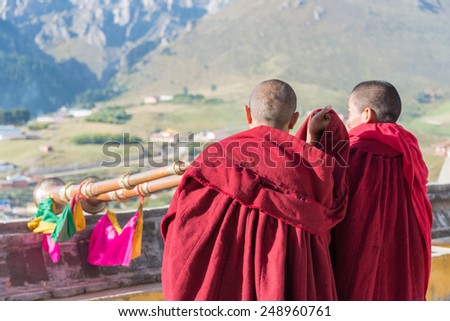 LANGMUSI CHINA SEP 25 2014 Tibetan Monk at Sertri Gompa Dacanglangmu Saichisi a famous Lamasery in Langmusi Gansu China LANGMUSI CHINA SEP 25 2014 Tibetan Monk at Sertri Gompa Dacanglangmu Saichisi a famous Lamasery in Langmusi Gansu China