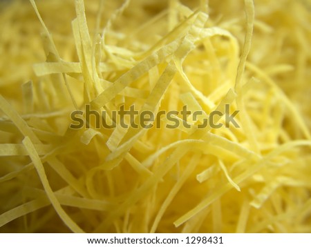 Yellow stripes of food. Interesting yellow background. Chaotic yellow backdrop of stripped food