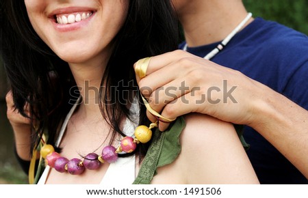 Girl getting necklace gift from a boy. Happy couple - girlfriend and boyfriend