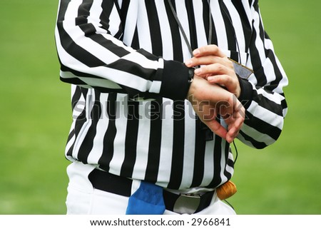 American football Referee looking on time. Sports justice concept