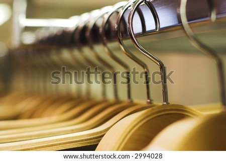 Clothes hangers in the fashion store.  Clothes store concept