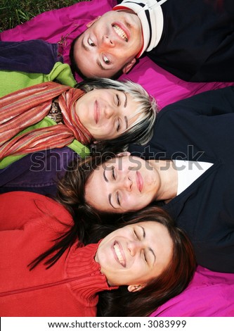 Young adults laugh. Happy friends smile and having fun. Friends laying together laughing