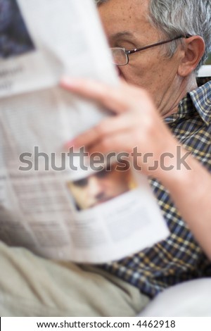 Senior man reading newspapers in leisure time
