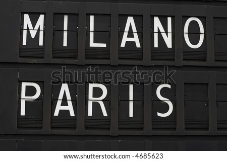 Flights info board on airport concept. Fashion cities Paris and Milan