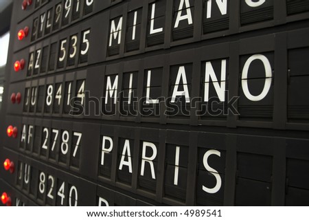 Flights info board on airport concept. Fashion cities Paris and Milano