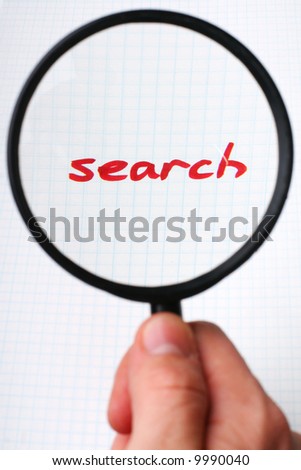 SEARCH on paper under magnifying glass. Hand writing font and internet concept