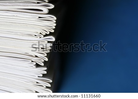 Stack of notebooks isolated on blue background. Education and school concept