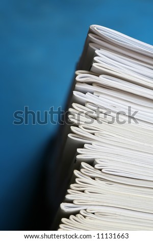 Stack of notebooks isolated on blue. Education and school concept